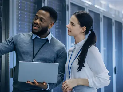 black male and white female IT professionals in a server room
