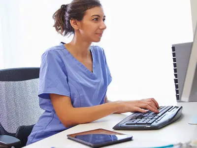 female healthcare worker working on the computer