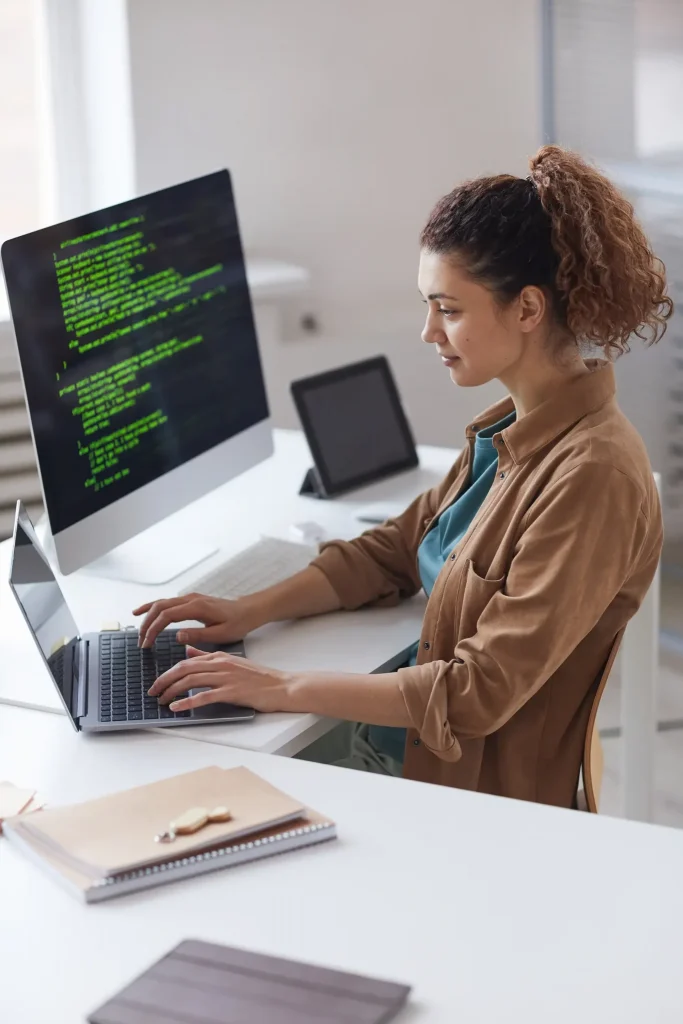 female software developer working on her computer