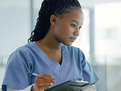 young black women healthcare worker holding clipboard