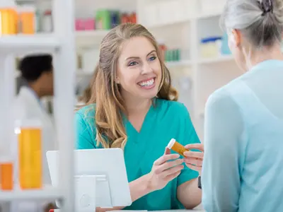 young pharmacy women helping out patient